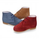 Classic suede leather ankle boots to dress for first steps.