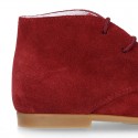 Classic suede leather ankle boots to dress for first steps.