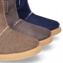 Autumn winter canvas ankle boots with hook and loop strap and fake hair lining.