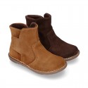 Kids ankle boots with double hook and loop strap closure in suede leather.