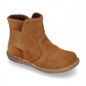 Kids ankle boots with double hook and loop strap closure in suede leather.