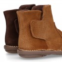 Kids ankle boots with double hook and loop strap closure in suede leather.