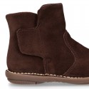 Kids ankle boots with double hook and loop strap closure in suede leather.