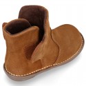 Kids ankle boots with double hook and loop strap closure in suede leather.