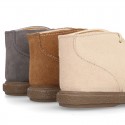 Suede leather booties with chopped design and shoelaces closure.