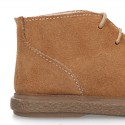 Suede leather booties with chopped design and shoelaces closure.