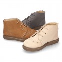 Suede leather booties with chopped design and shoelaces closure.