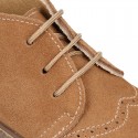 Suede leather booties with chopped design and shoelaces closure.