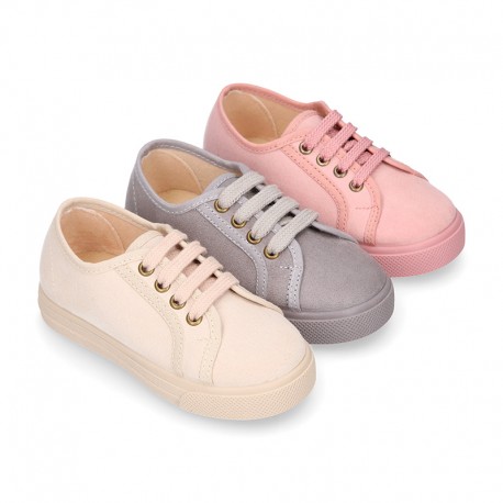 Autumn winter canvas OKAA kids tennis shoes to dress with shoelaces closure in pastel colors.