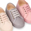 Autumn winter canvas OKAA kids tennis shoes to dress with shoelaces closure in pastel colors.