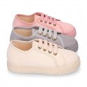 Autumn winter canvas OKAA kids tennis shoes to dress with shoelaces closure in pastel colors.