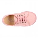 Autumn winter canvas OKAA kids tennis shoes to dress with shoelaces closure in pastel colors.