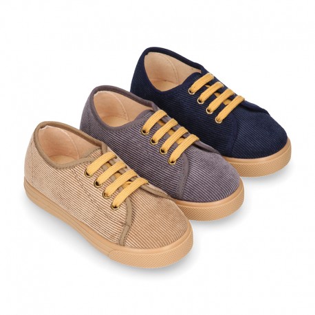 Corduroy canvas OKAA kids tennis shoes to dress with shoelaces closure.