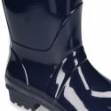 Knee high rain boots in plain colors with glossy finish, in large sizes.