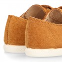 Kids suede leather Tennis type shoes with laceless and toe cap in TAN color.