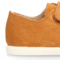 Kids suede leather Tennis type shoes with laceless and toe cap in TAN color.