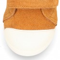 Kids suede leather Tennis type shoes with laceless and toe cap in TAN color.