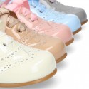 Classic Patent leather Laces up shoes in soft colors.