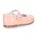 Patent leather little Mary Janes with button fastening.