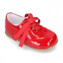 Classic Laces up shoes in red patent leather.