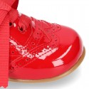 Classic Laces up shoes in red patent leather.