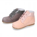 Classic patent leather ankle boots to dress combined with soft suede leather for first steps.