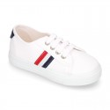 Cotton canvas kids tennis shoes to dress with shoelaces and flag design.