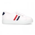 Cotton canvas kids tennis shoes to dress with shoelaces and flag design.