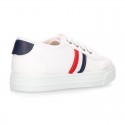 Cotton canvas kids tennis shoes to dress with shoelaces and flag design.