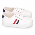 Cotton canvas kids tennis shoes to dress with shoelaces and flag design.