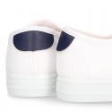 Cotton canvas kids tennis shoes to dress with shoelaces and flag design.