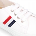 Cotton canvas kids tennis shoes to dress with shoelaces and flag design.