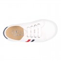 Cotton canvas kids tennis shoes to dress with shoelaces and flag design.