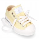 Cotton canvas Sneaker shoes with shoelaces and with toe cap in pastel colors.