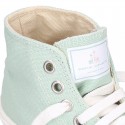 Cotton canvas High Sneaker shoes with shoelaces and with toe cap in pastel colors.