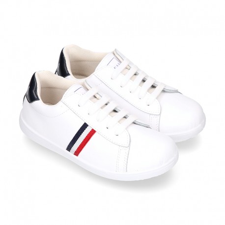 Washable leather OKAA kids School tennis shoes with laces and flag design.