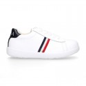 Washable leather OKAA kids School tennis shoes with laces and flag design.