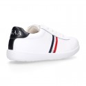 Washable leather OKAA kids School tennis shoes with laces and flag design.