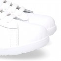 Washable leather OKAA kids School tennis shoes with laces and flag design.