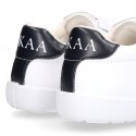 Washable leather OKAA kids School tennis shoes with laces and flag design.