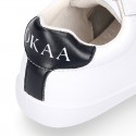 Washable leather OKAA kids School tennis shoes with laces and flag design.