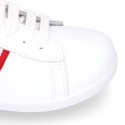 Washable leather OKAA kids School tennis shoes with laces and flag design.