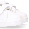 White color OKAA FLEX girl tennis shoes laceless.