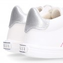 White color OKAA FLEX girl tennis shoes laceless.