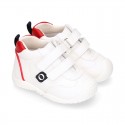 White color OKAA FLEX tennis kids shoes laceless and with toe cap.