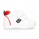 White color OKAA FLEX tennis kids shoes laceless and with toe cap.