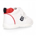 White color OKAA FLEX tennis kids shoes laceless and with toe cap.