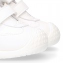 White color OKAA FLEX tennis kids shoes laceless and with toe cap.