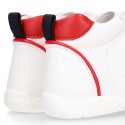 White color OKAA FLEX tennis kids shoes laceless and with toe cap.