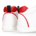 White color OKAA FLEX tennis kids shoes laceless and with toe cap.